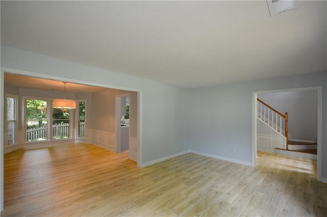9050 Brockham Way, Alpharetta, GA 30022 - spare room with light wood-type flooring and stairs