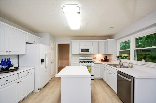 9050 Brockham Way, Alpharetta, GA 30022 - kitchen featuring white appliances, a sink, a center island, and white cabinets