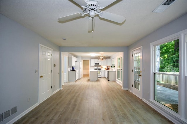 9050 Brockham Way, Alpharetta, GA 30022 - unfurnished living room featuring light wood finished floors, baseboards, and ceiling fan
