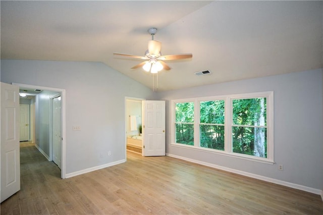 9050 Brockham Way, Alpharetta, GA 30022 - unfurnished bedroom featuring lofted ceiling, light wood finished floors, baseboards, and connected bathroom