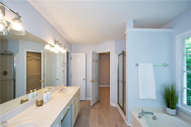 9050 Brockham Way, Alpharetta, GA 30022 - full bathroom featuring a stall shower, double vanity, a textured ceiling, wood finished floors, and a spacious closet