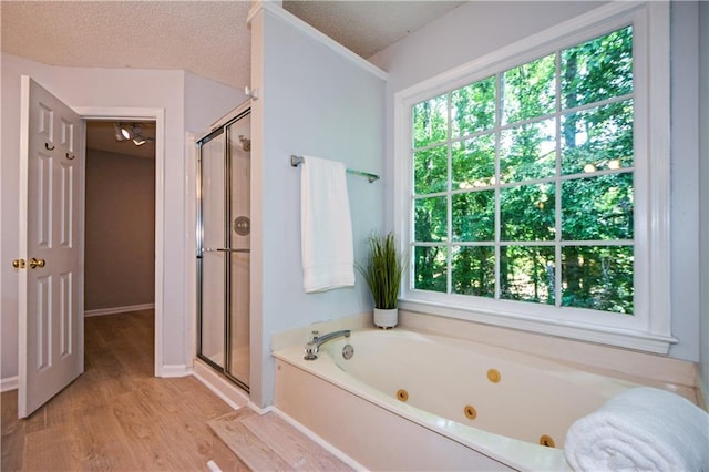 9050 Brockham Way, Alpharetta, GA 30022 - bathroom with plenty of natural light, a shower stall, a jetted tub, and a textured ceiling