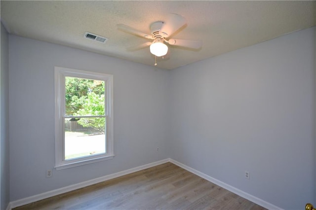 9050 Brockham Way, Alpharetta, GA 30022 - unfurnished room featuring light wood finished floors, a ceiling fan, baseboards, and a textured ceiling