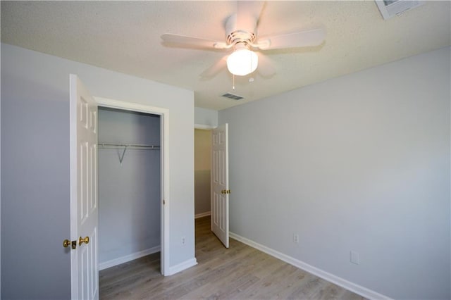 9050 Brockham Way, Alpharetta, GA 30022 - unfurnished bedroom with wood finished floors, a closet, baseboards, a textured ceiling, and a ceiling fan