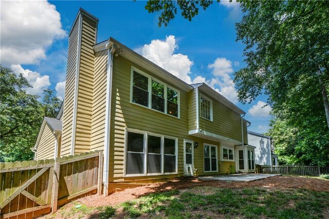 9050 Brockham Way, Alpharetta, GA 30022 - back of house with a chimney and a patio area
