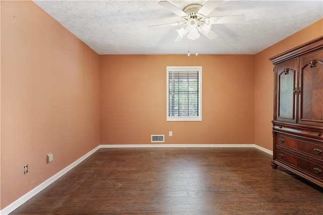 unfurnished room with a textured ceiling, dark hardwood / wood-style floors, and ceiling fan