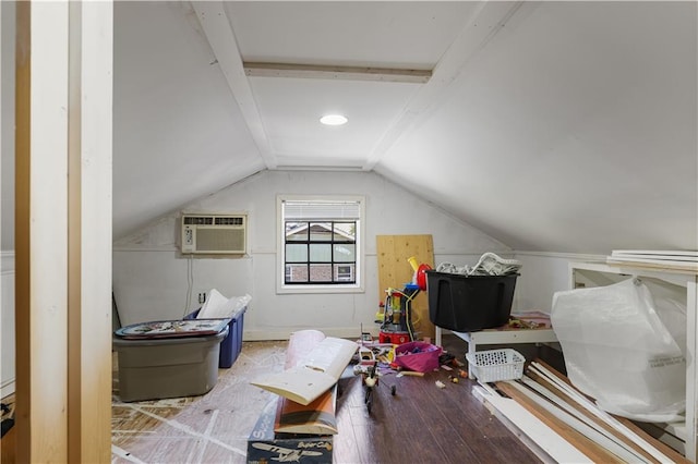 additional living space featuring hardwood / wood-style floors, vaulted ceiling, and a wall mounted air conditioner