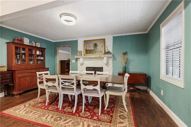 dining space featuring ornamental molding, a fireplace, and dark hardwood / wood-style flooring