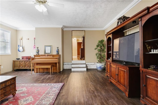 interior space with ceiling fan, ornamental molding, a textured ceiling, and dark hardwood / wood-style floors