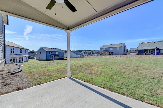 view of yard featuring ceiling fan and a patio