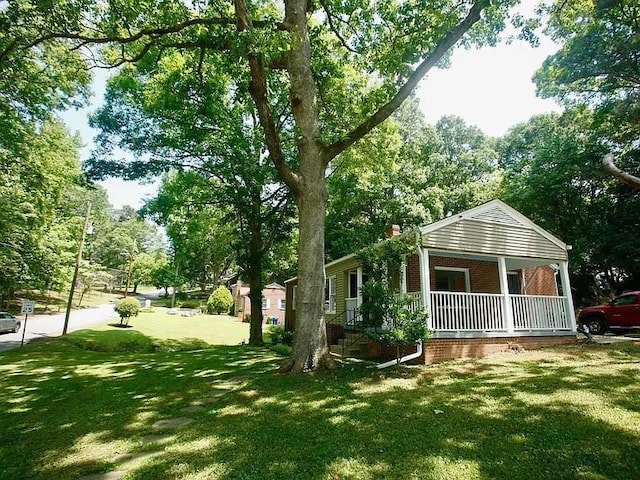 view of yard with covered porch