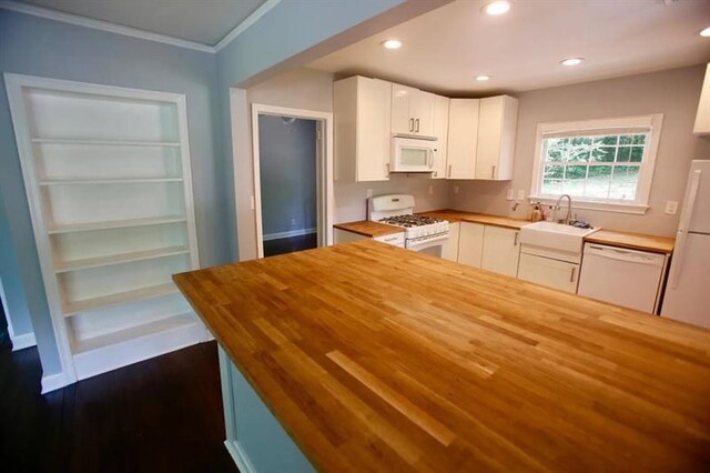 kitchen with recessed lighting, butcher block counters, white appliances, a sink, and white cabinets