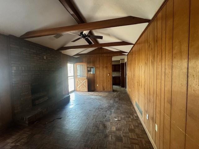 3415 Spring Valley Blvd, Atlanta, GA 30349 - unfurnished living room featuring wooden walls, ceiling fan, and a brick fireplace