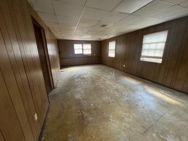 3415 Spring Valley Blvd, Atlanta, GA 30349 - unfurnished room featuring unfinished concrete floors, wood walls, and a drop ceiling