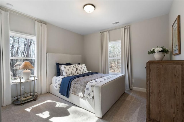 bedroom featuring carpet and baseboards