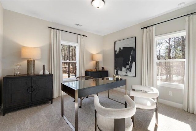 office with light carpet and baseboards
