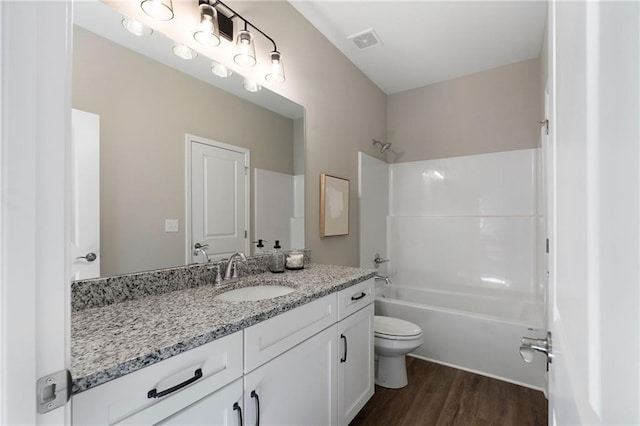 full bathroom featuring toilet,  shower combination, wood finished floors, and vanity