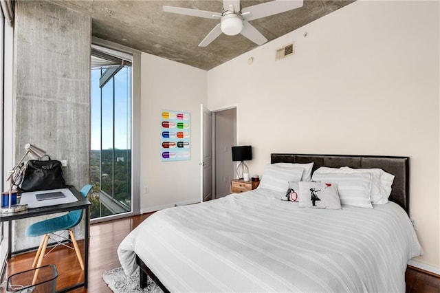 bedroom featuring baseboards, visible vents, ceiling fan, wood finished floors, and access to outside