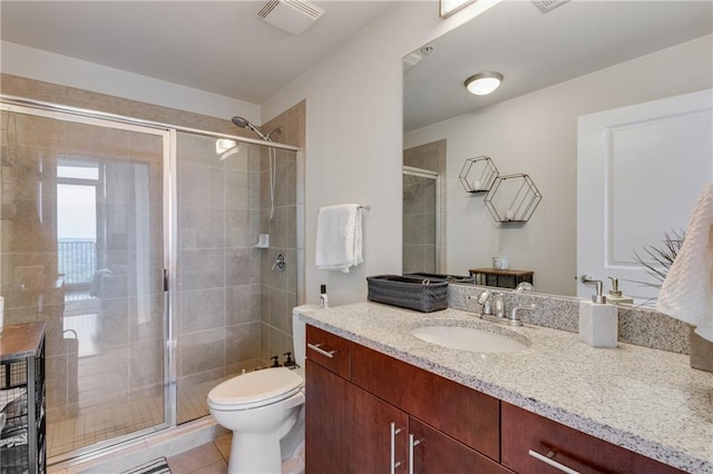 full bathroom featuring visible vents, toilet, a stall shower, vanity, and tile patterned flooring