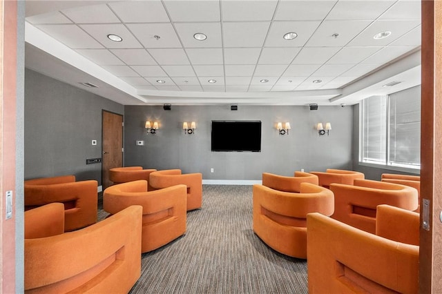 carpeted cinema room with visible vents, baseboards, a raised ceiling, and recessed lighting