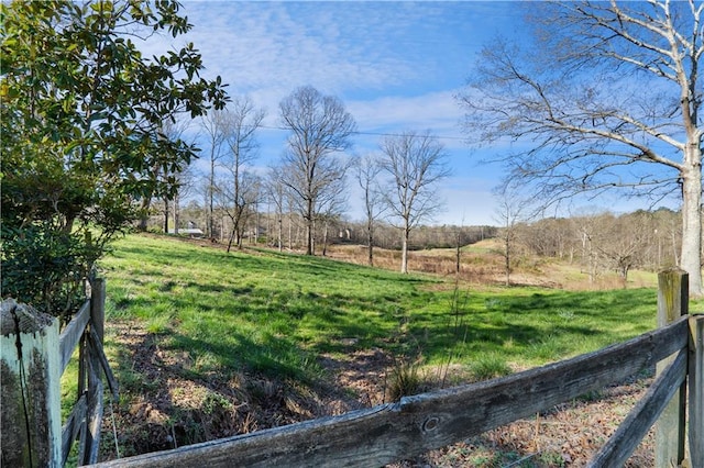 view of yard featuring a rural view and fence