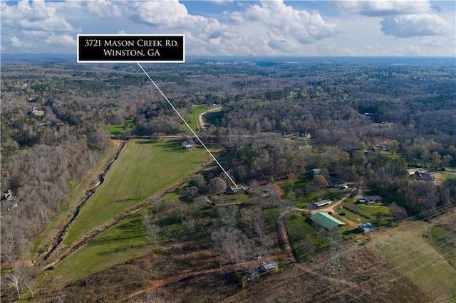 bird's eye view featuring a rural view and a wooded view