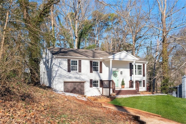 split foyer home with a garage and a front lawn