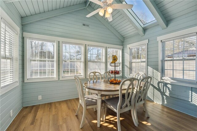 sunroom with lofted ceiling with skylight and ceiling fan