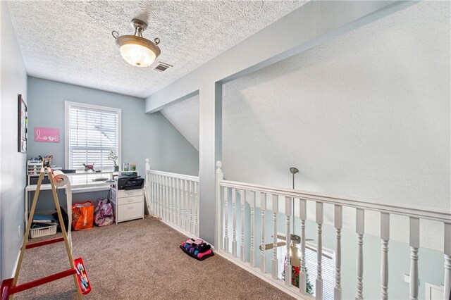 rec room with carpet, a textured ceiling, and lofted ceiling