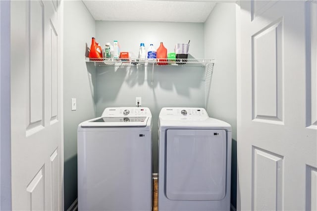 washroom featuring washer and clothes dryer