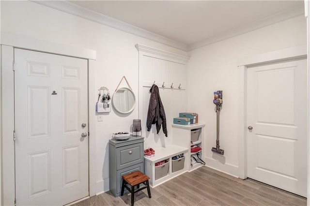 mudroom with crown molding and hardwood / wood-style floors