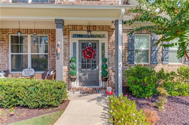 view of exterior entry with covered porch