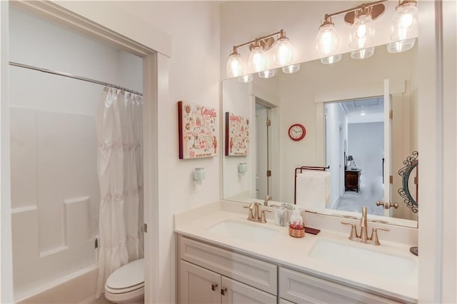 full bathroom featuring shower / tub combo, vanity, and toilet