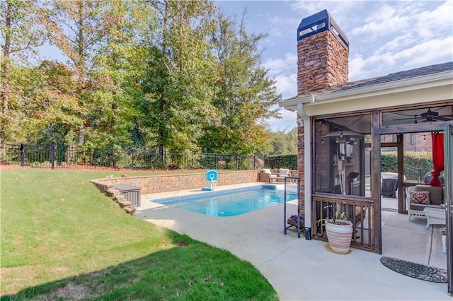 view of swimming pool featuring a patio and a yard