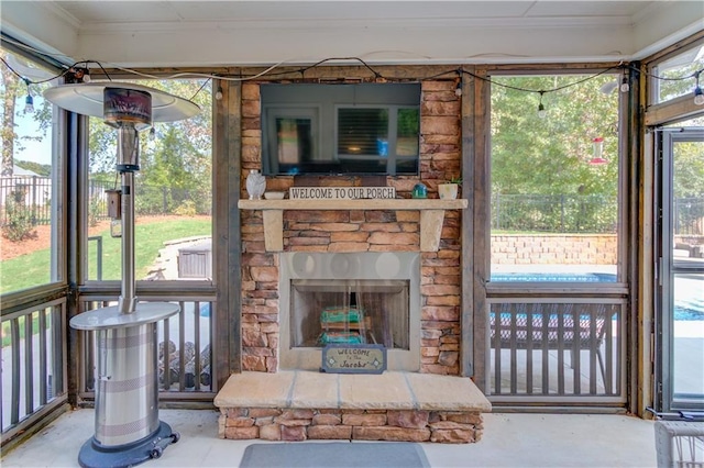 sunroom / solarium with a fireplace