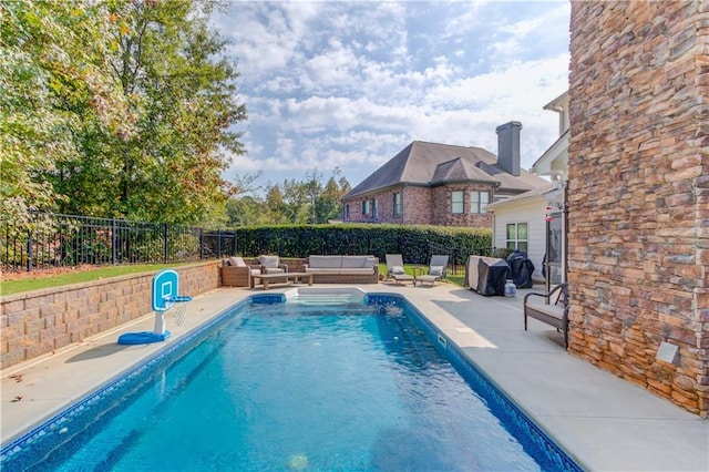 view of swimming pool with outdoor lounge area and a patio