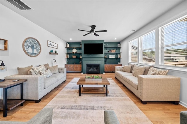 232 Northridge Dr, Dallas, GA 30132 - living area with light wood-type flooring, a ceiling fan, a glass covered fireplace, and recessed lighting