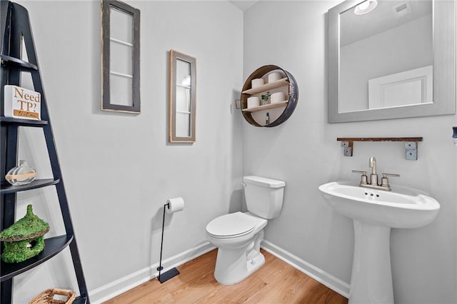 232 Northridge Dr, Dallas, GA 30132 - half bathroom with wood finished floors, toilet, and baseboards