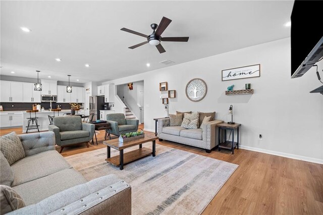232 Northridge Dr, Dallas, GA 30132 - living area featuring light wood-type flooring, stairway, a ceiling fan, baseboards, and recessed lighting