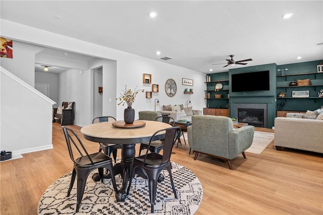 232 Northridge Dr, Dallas, GA 30132 - dining area with a ceiling fan, light wood-style flooring, a glass covered fireplace, stairway, and recessed lighting