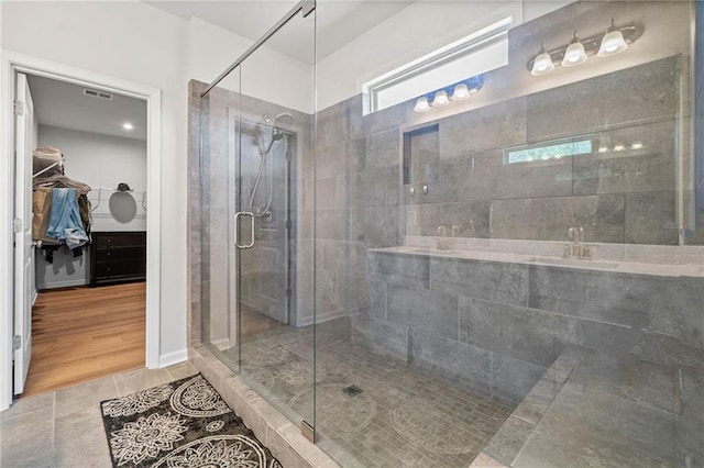 232 Northridge Dr, Dallas, GA 30132 - bathroom featuring a stall shower, a spacious closet, a sink, and tile patterned floors