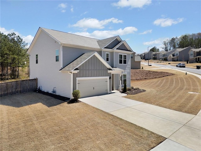 232 Northridge Dr, Dallas, GA 30132 - view of front of property with board and batten siding, fence, concrete driveway, and roof with shingles
