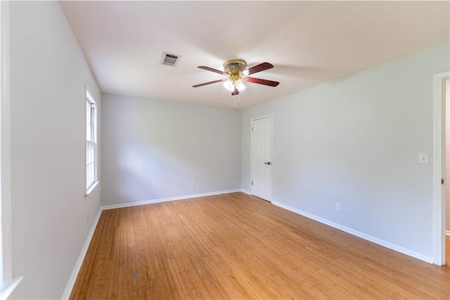unfurnished room featuring a ceiling fan, baseboards, and light wood-style floors