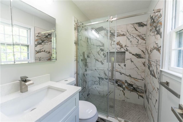 bathroom featuring toilet, healthy amount of natural light, and a marble finish shower