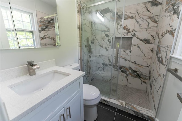 bathroom with toilet, a marble finish shower, and vanity
