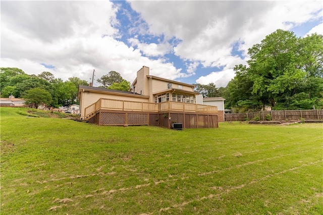 rear view of house featuring a wooden deck and a chimney