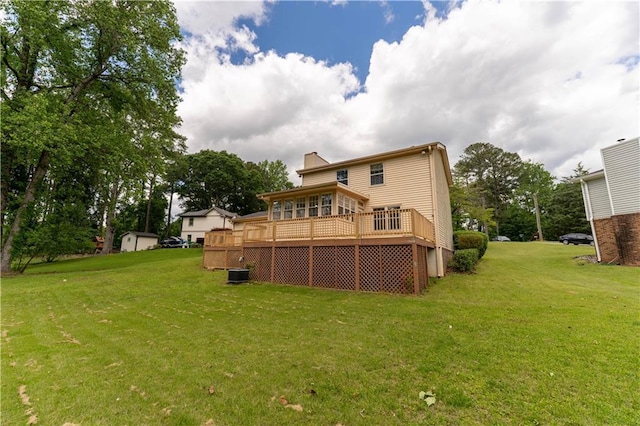 back of property featuring a yard, a deck, and central AC