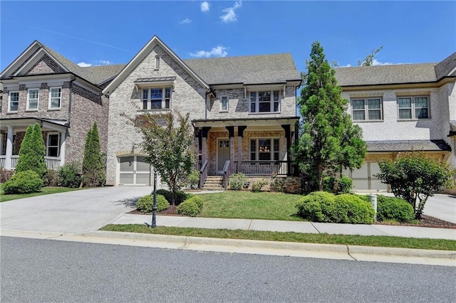 12095 Cameron Dr, Duluth, GA 30097 - view of front facade with driveway, a garage, covered porch, brick siding, and a front lawn
