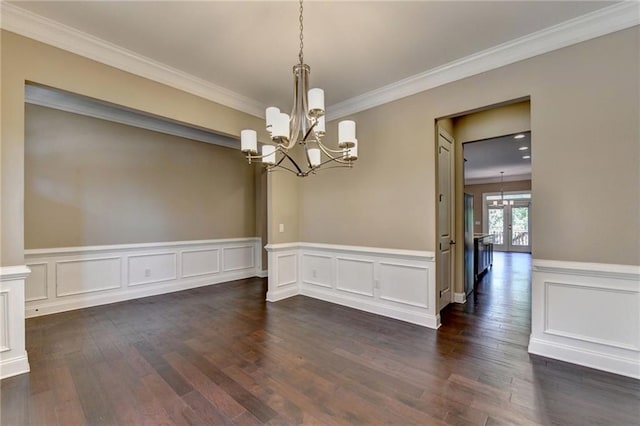 12095 Cameron Dr, Duluth, GA 30097 - unfurnished room with a chandelier, dark wood-style flooring, ornamental molding, wainscoting, and a decorative wall