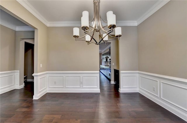 12095 Cameron Dr, Duluth, GA 30097 - unfurnished dining area featuring a chandelier, dark wood-type flooring, ornamental molding, wainscoting, and a decorative wall